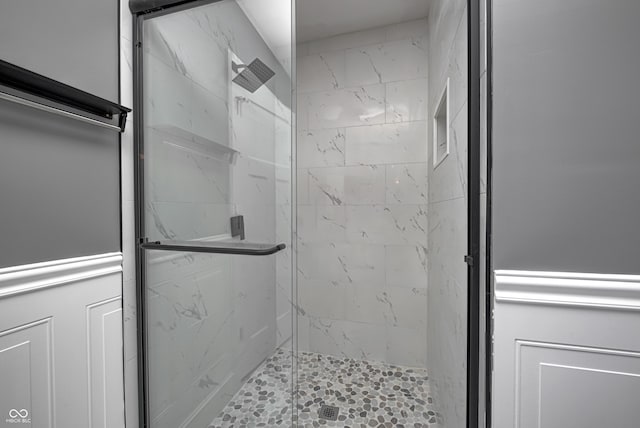 bathroom featuring a shower with door