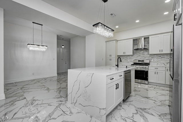 kitchen with white cabinetry, sink, wall chimney range hood, and stainless steel appliances