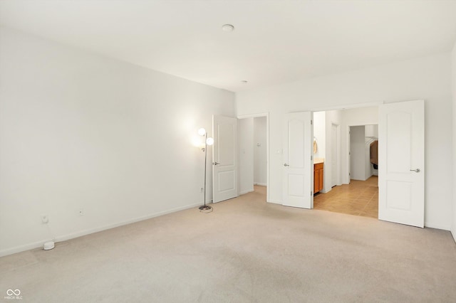 unfurnished bedroom featuring light colored carpet