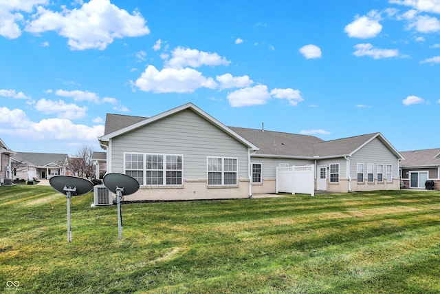 rear view of property with a lawn