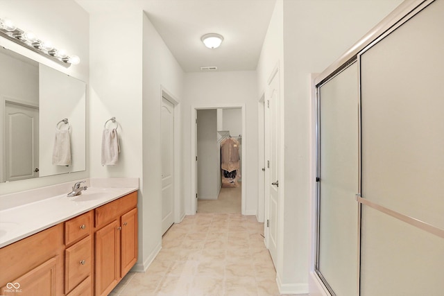 bathroom featuring vanity and an enclosed shower