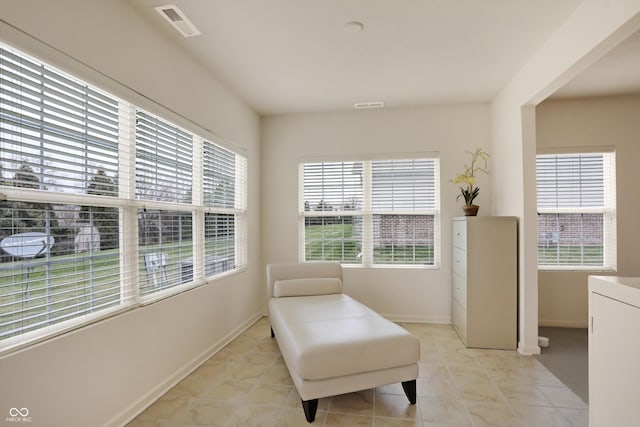 sitting room featuring light tile patterned flooring and a healthy amount of sunlight