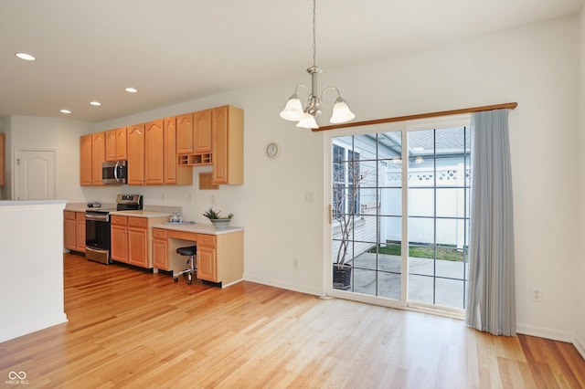 kitchen featuring a chandelier, light hardwood / wood-style floors, decorative light fixtures, and appliances with stainless steel finishes