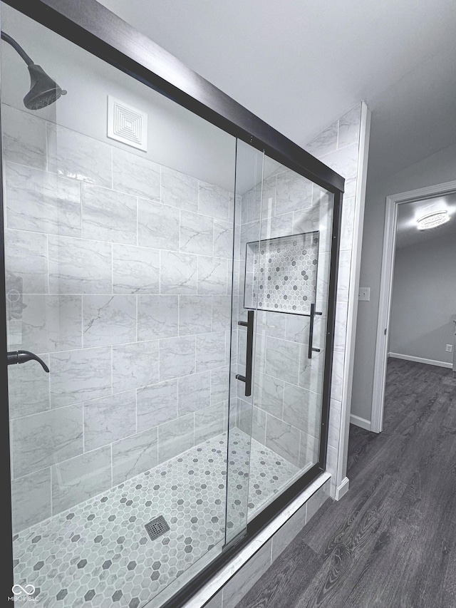 bathroom featuring hardwood / wood-style floors and an enclosed shower