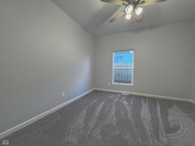 empty room with carpet flooring, ceiling fan, and vaulted ceiling