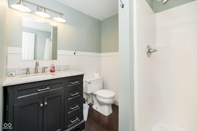 bathroom featuring vanity, hardwood / wood-style flooring, toilet, and curtained shower