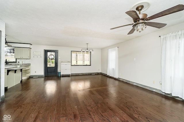 interior space featuring a textured ceiling, ceiling fan, and dark hardwood / wood-style floors