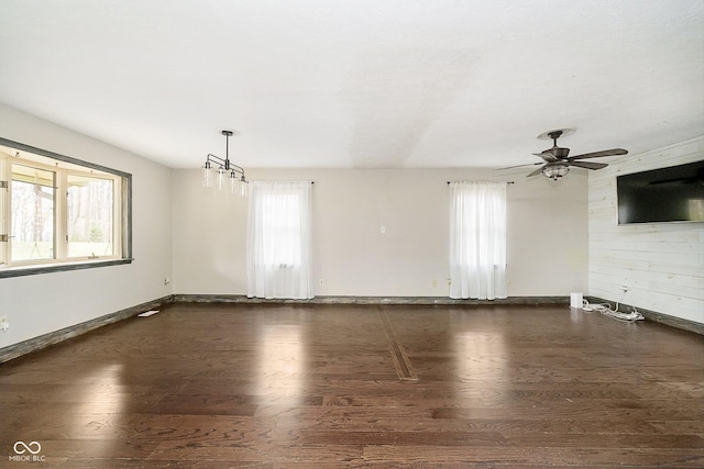 spare room with plenty of natural light, dark wood-type flooring, and ceiling fan