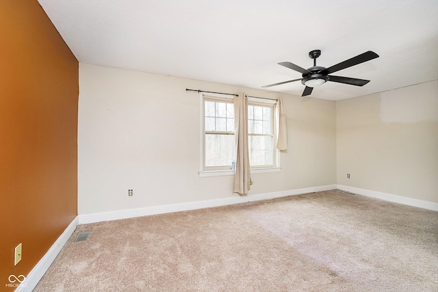 empty room with ceiling fan and carpet floors