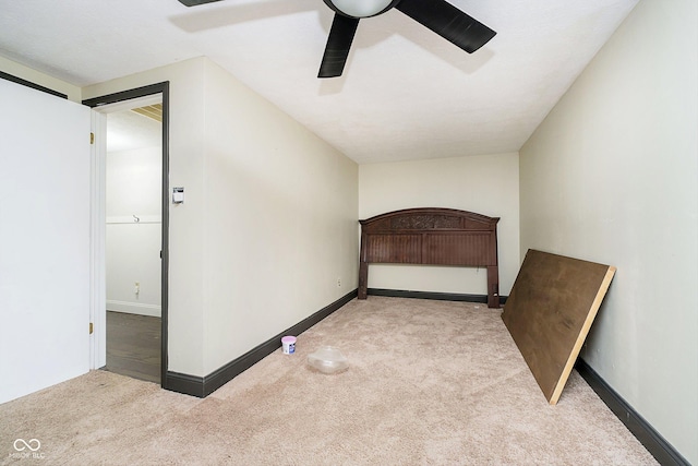 unfurnished bedroom featuring ceiling fan and light colored carpet