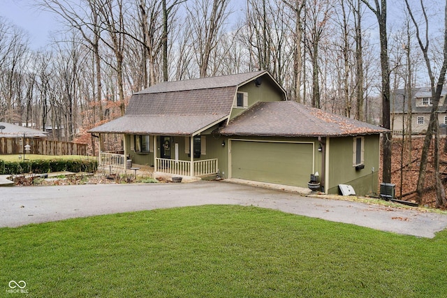 front of property featuring a front lawn, covered porch, and a garage