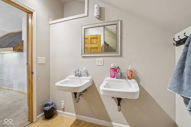 bathroom featuring vaulted ceiling and sink