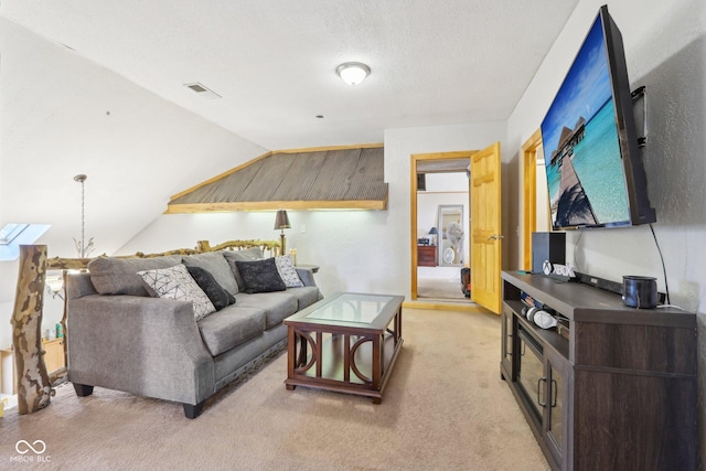 carpeted living room with vaulted ceiling and a textured ceiling