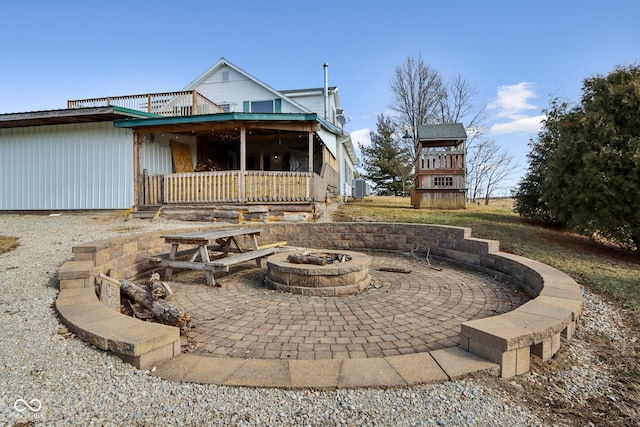 exterior space with central AC, an outdoor fire pit, and a patio area