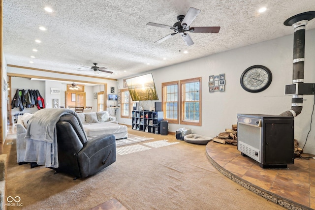 living room with ceiling fan, carpet, and a textured ceiling