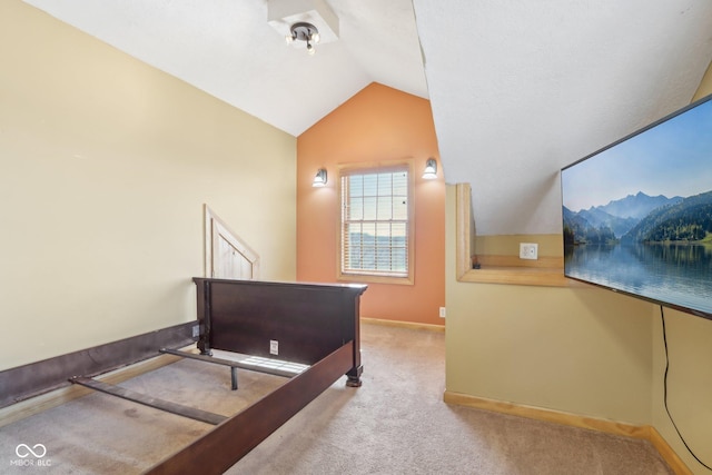 carpeted bedroom featuring lofted ceiling