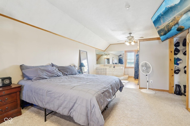 bedroom featuring ceiling fan, vaulted ceiling, and light carpet