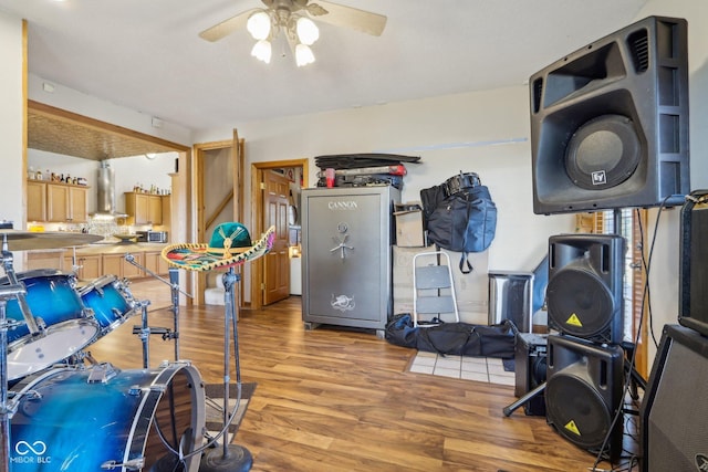 workout area with hardwood / wood-style floors and ceiling fan