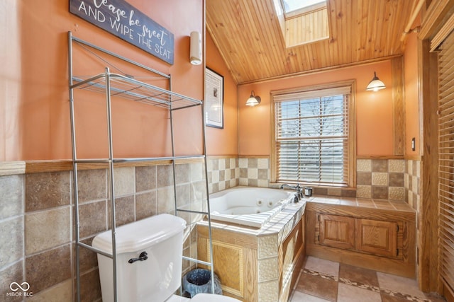 bathroom featuring wood ceiling, tile walls, a bathtub, lofted ceiling with skylight, and toilet