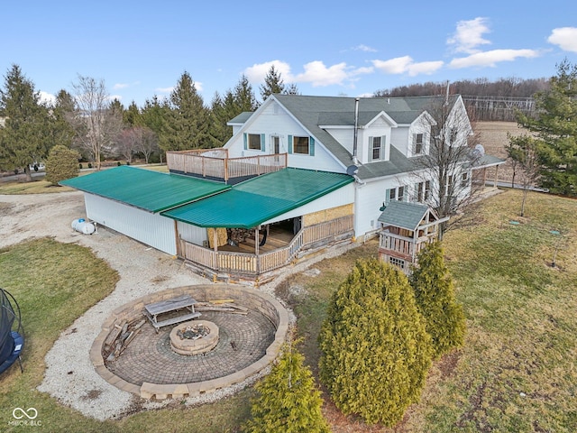 exterior space with an outdoor fire pit and a yard