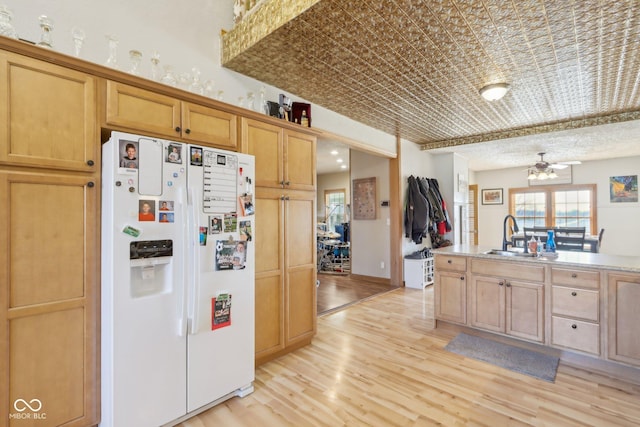 kitchen with sink, light hardwood / wood-style floors, white fridge with ice dispenser, and ceiling fan