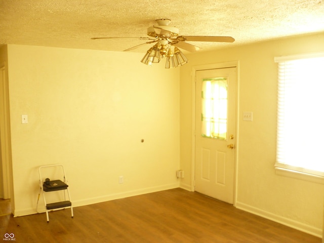 interior space with hardwood / wood-style floors, a textured ceiling, and ceiling fan