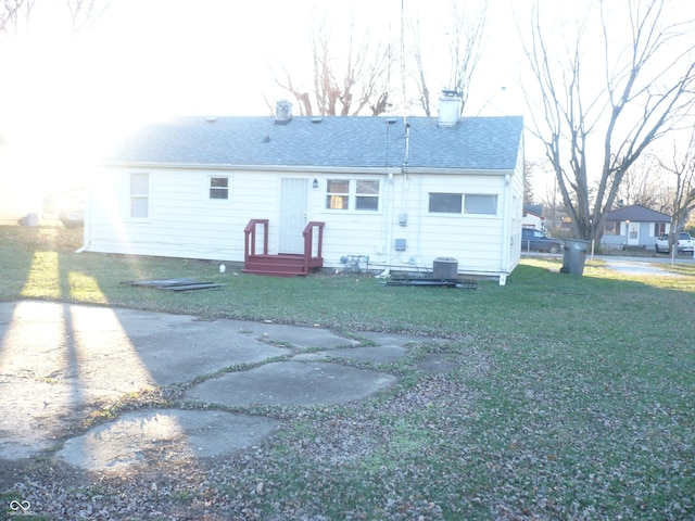 back of property with a lawn