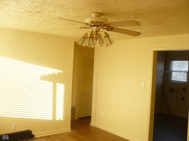 empty room featuring hardwood / wood-style floors, a textured ceiling, and ceiling fan