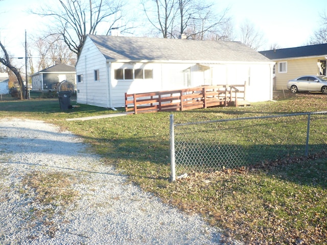 view of side of home with a lawn