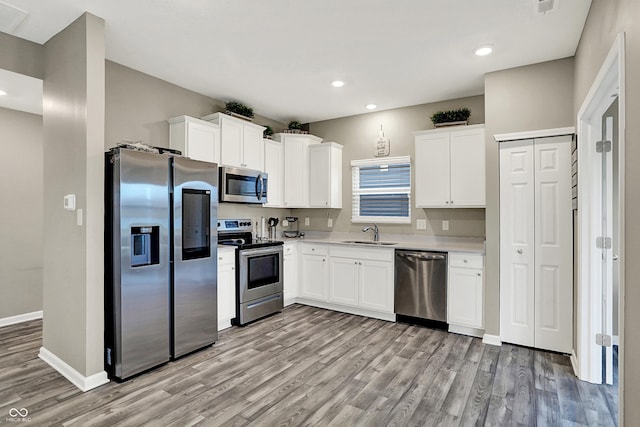 kitchen featuring white cabinetry, sink, and stainless steel appliances