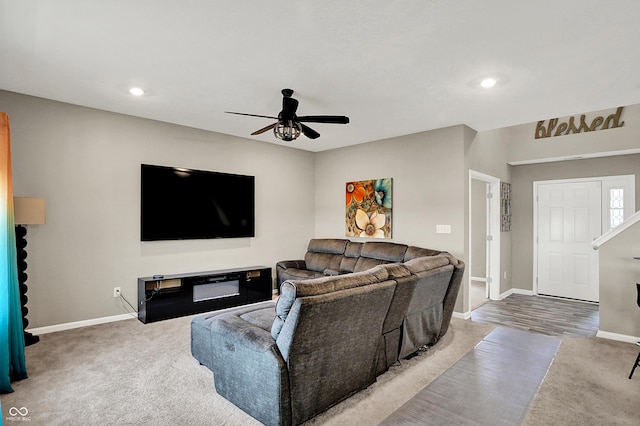 carpeted living room featuring ceiling fan