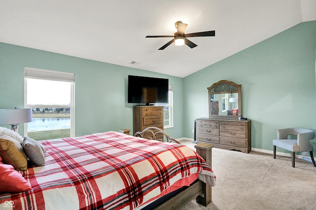 carpeted bedroom featuring ceiling fan and vaulted ceiling