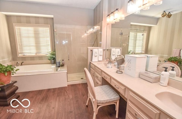 bathroom featuring vanity, wood-type flooring, and shower with separate bathtub