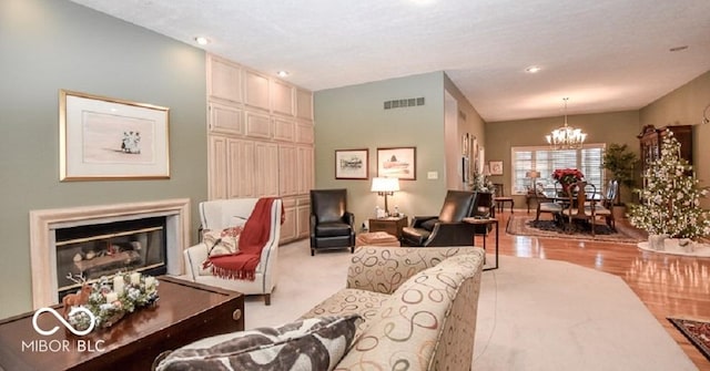 living room featuring light wood-type flooring and a notable chandelier