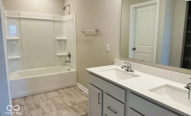 bathroom with vanity, wood-type flooring, and  shower combination