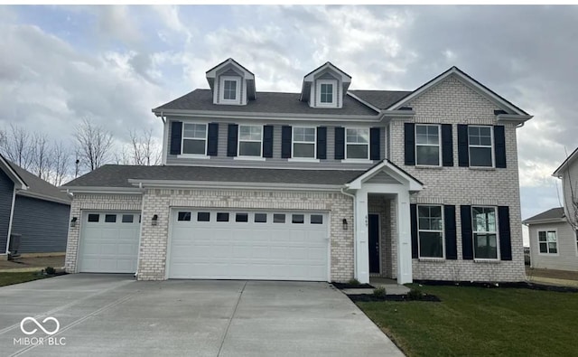 view of front of home with a garage and a front lawn