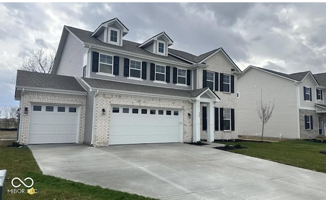 view of front of home featuring a garage and a front lawn