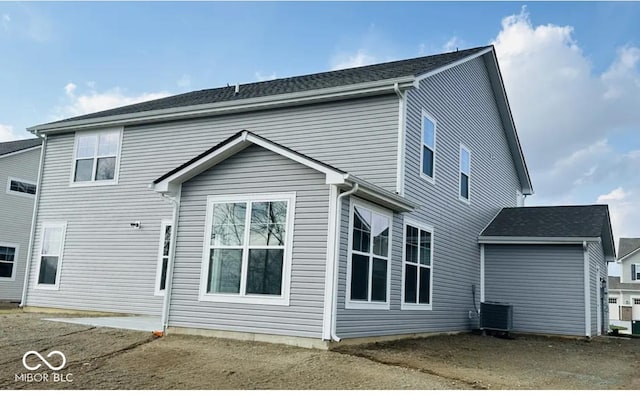 rear view of house featuring central AC