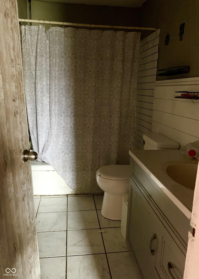 bathroom with tile patterned flooring, vanity, toilet, and a shower with curtain