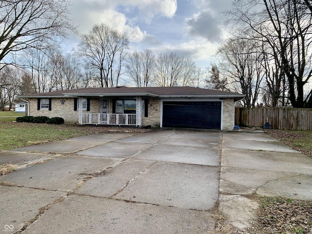 single story home featuring a porch and a garage