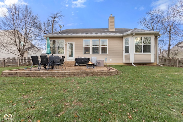 back of house with a lawn and a patio area