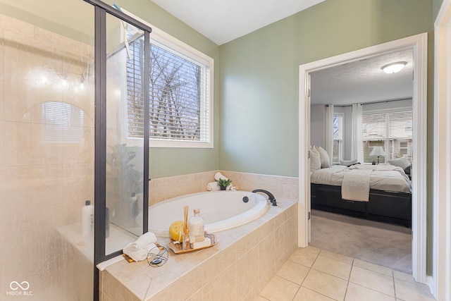 bathroom featuring tile patterned floors and independent shower and bath