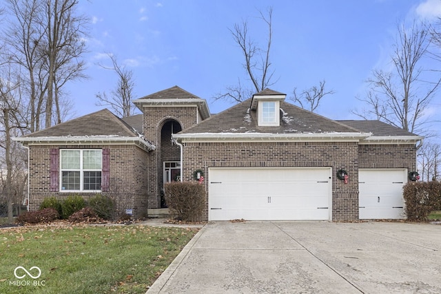 view of front of house with a garage and a front yard