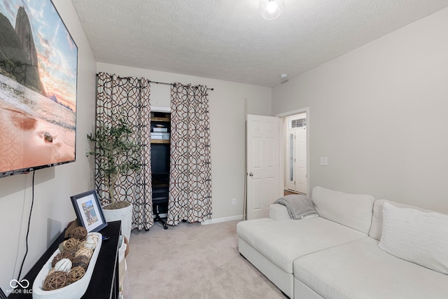 carpeted living room featuring a textured ceiling