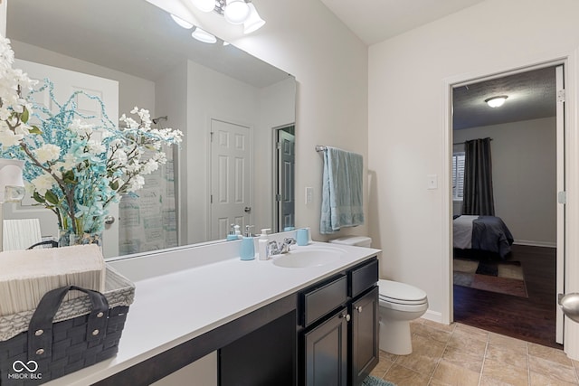 bathroom with vanity, wood-type flooring, and toilet