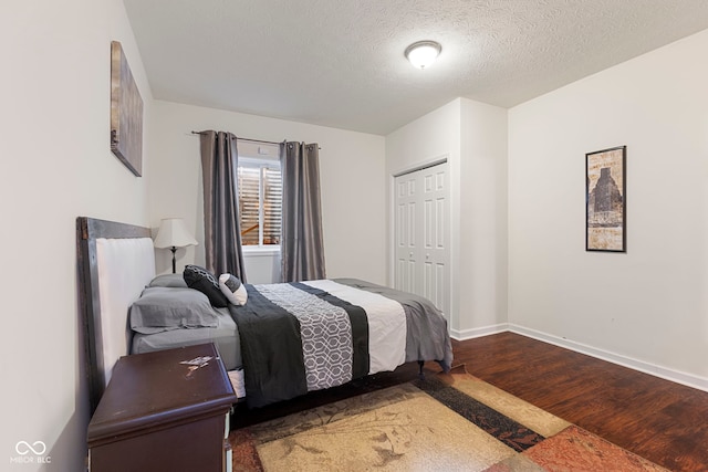 bedroom featuring a closet, wood-type flooring, and a textured ceiling