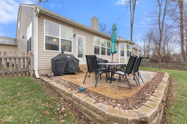 back of property with a patio area and a lawn