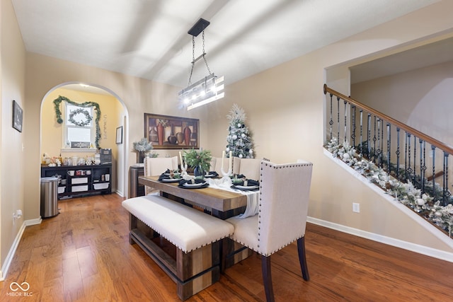 dining area featuring a notable chandelier and hardwood / wood-style flooring