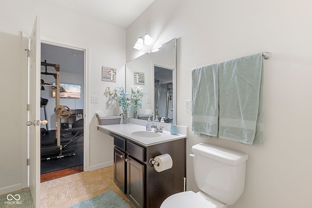 bathroom featuring tile patterned floors, vanity, and toilet