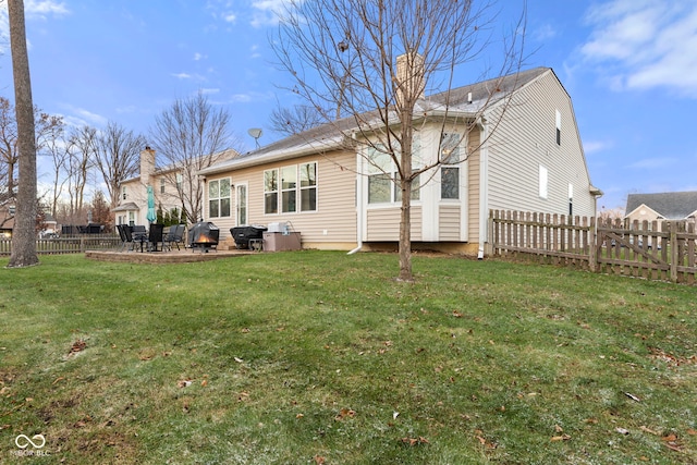 back of house featuring a patio and a lawn